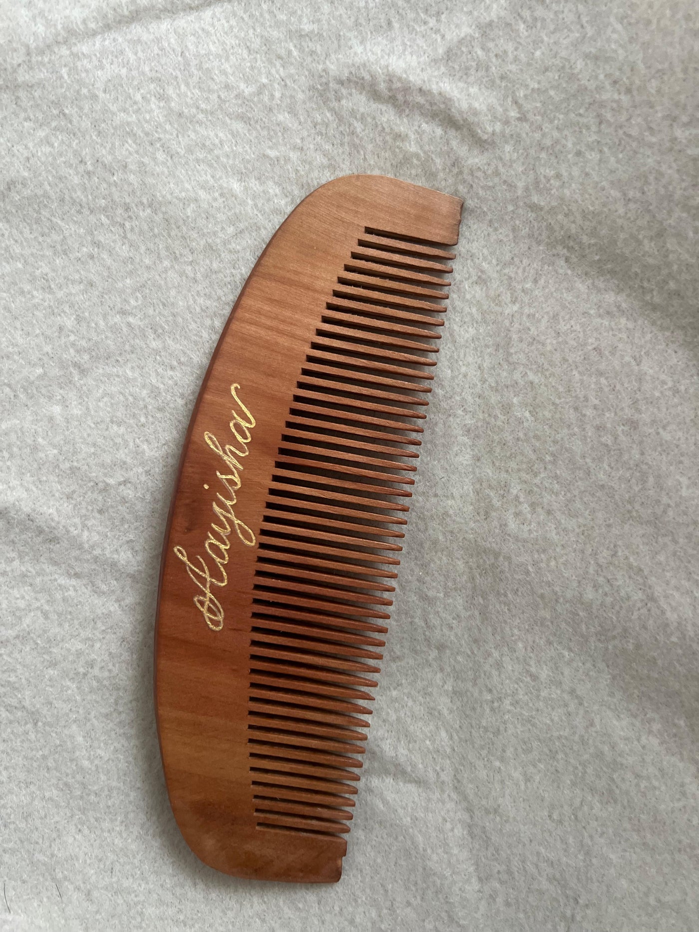 Personalised name engraving on a wooden comb